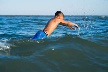 Teenager  boy enjoying a swimming in the sea.