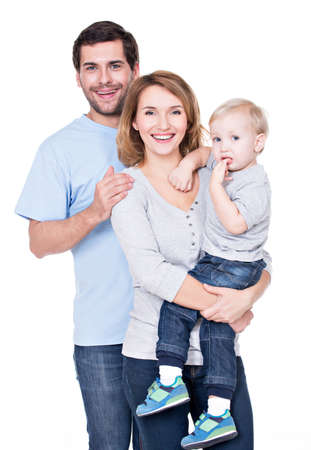 Portrait of the happy family with little baby standing on white background.の写真素材