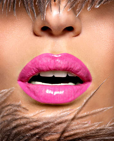 Closeup Beautiful female lips with pink  lipstick.  Glamour fashion bright gloss make-up.の写真素材
