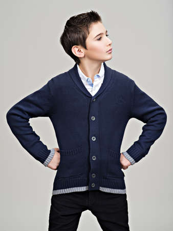Beautiful teenage boy posing at studio as a fashion model.の写真素材