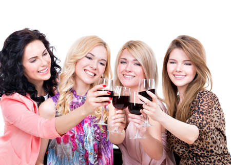 Portrait of young happy women having fun and drinking red wine - isolated on white.の写真素材