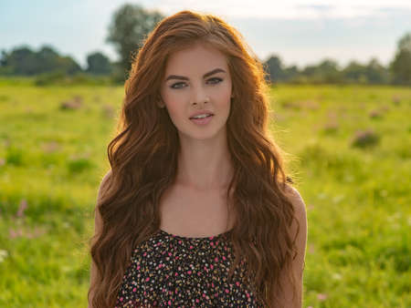 Young woman posing in nature on a nice summer day
