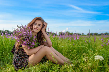 Woman outdoors with a bouquet of lavenderの写真素材