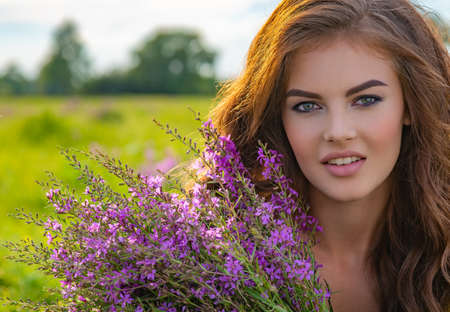 Girl in a field with lavender flowers in her hands