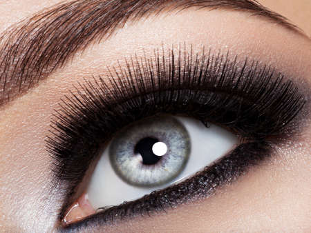 woman's eye with black eye makeup. Macro style image. Long eyelashesの写真素材