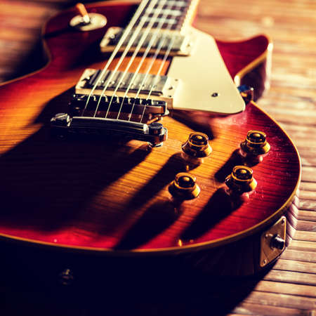 Old Vintage electric guitar body close-up view is on the wood floor