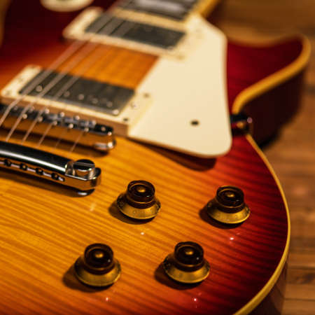 electric guitar body close-up view is on the wood floor