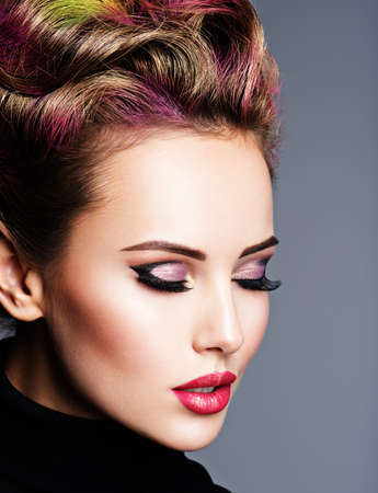Beautiful woman with closed eyes. Fashion model with red lips - posing at studio