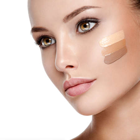 Beautiful face of  young woman with cosmetic foundation on a skin.   Beauty treatment conceptの写真素材