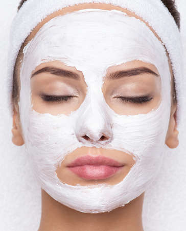 Adult woman relaxing in spa salon with cosmetic mask on face. Beauty treatmentの写真素材