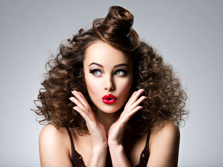 Beautiful wonder woman with creative fashion hairstyle. Surprised adult  girl