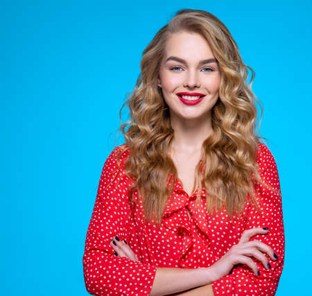 Portrait of a happy young blonde. Beautiful smiling girl with long white hair. Model in a red shirt...