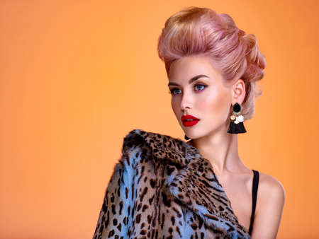Beautiful woman with style hairstyle. White woman with bright colored makeup. Fashionable young...