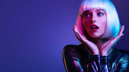 Surprised  Face of glamour girl. Wondered female face in a white wig. Young beautiful woman with a...