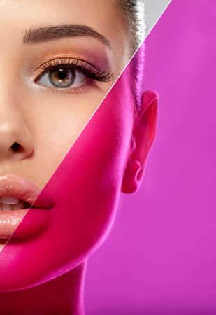 Beautiful white girl with bright eye-makeup. Beautiful fashion woman with  a colored  items.   Glamour fashion model with bright gloss make-up posing at studio. Stylish fashionable concept. Art.の写真素材