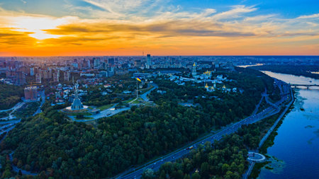 Aerial view to the  Beautiful landscape city Kiev with a Dnepr river while sunset. Top view to the city Kiev in the summer. Beautiful city Kiev while sunset.の写真素材