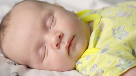 Infant sleeping at home. Small baby sleeping. Close-up shot of infant sleeping. Macro shot of a...