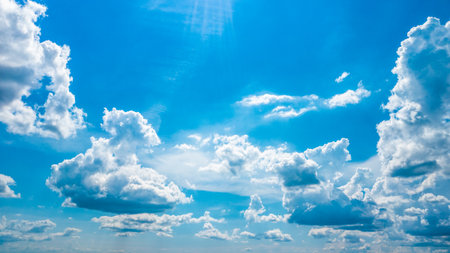 Photo of clouds on a sunny day. Beautiful white clouds on a bright summer day with the sun shining...