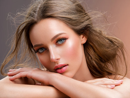 Beautiful white girl with red lips looks to the camera. Stunning blonda girl. Closeup face of young beautiful woman with a healthy clean skin. Pretty woman with bright  makeup of eyes.の写真素材