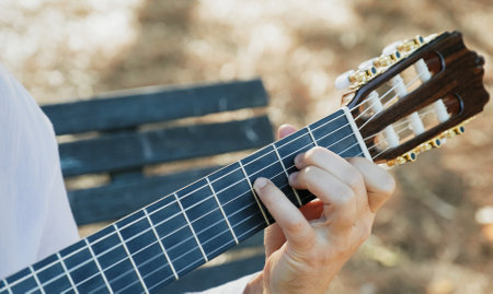 Close-up of the musician's playing hands. The guitarist plays the guitar. Professional guitarist...
