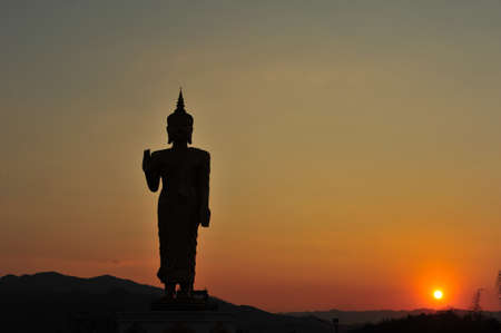 Silhouette buddha statue in sunsetの写真素材