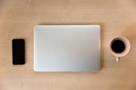 Silver laptop close with equipment to process work, view from aboveの写真素材