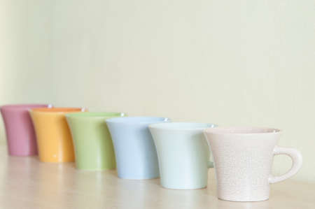 Row of colorful coffee cups on clear background.の写真素材