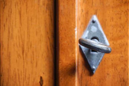 Wooden door with vintage blur key and focus at keyhole