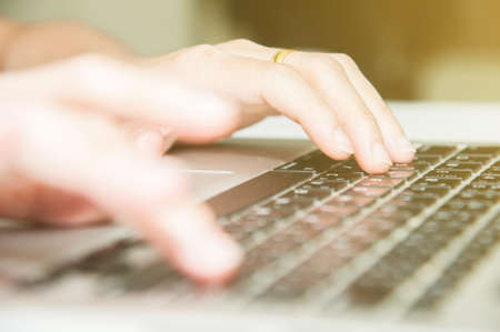 Close view finger press button on laptop keyboard