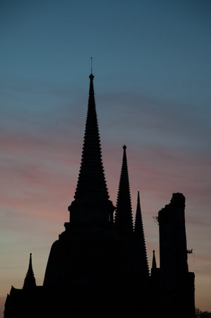 Silhouette and vertical of three pagoda of Wat Phra Sri Sanphet, famous historic site in Ayutthaya province, Thailand, twilight scene and smooth skyの写真素材