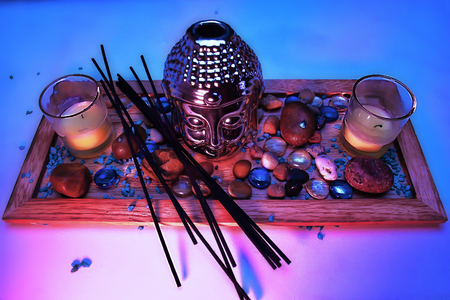 Buddha on the white backround & candles bamboo mat aramatized sticks colored glass pebbles colored sandの写真素材