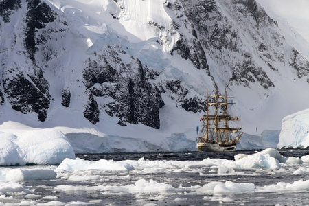 Graham Land, Antarctic Peninsula - February 14 2011: three-masted Dutch tall ship 'bark Europe' anchored in Orne Harbor. A popular excursion site for tourist expeditions.のeditorial素材