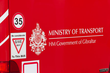 GIBRALTAR, UNITED KINGDOM - FEBRUARY 9, 2018: Public transport iconic red bus. Rear end decorated with the coat of arms from the Government of Gibraltar.のeditorial素材