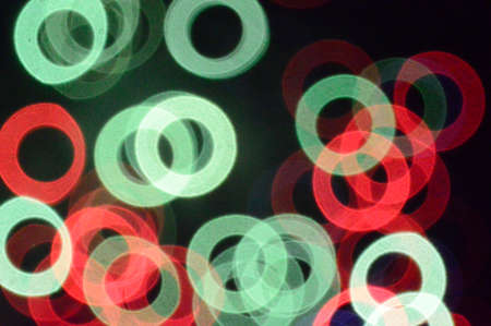 Composition of various luminous green and red circles on black backgroundの写真素材
