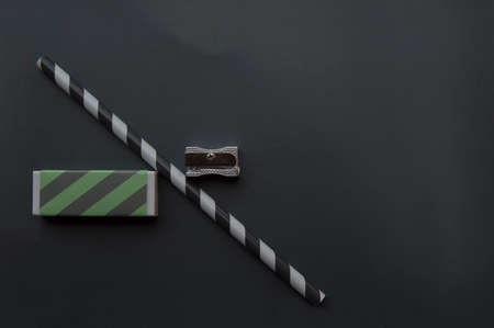 Gray background with a pencil, a pencil sharpener and an eraserの写真素材