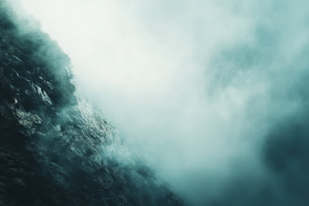 A rocky mountainside shrouded in mist and clouds.の素材