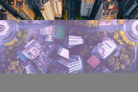Aerial view of city roundabout surrounded by skyscrapers.の素材