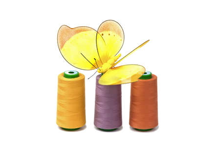 Coloreds spools with butterfly  isolated on white background