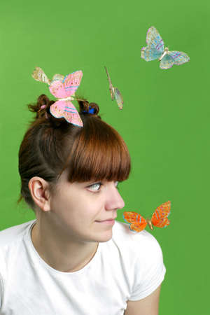 Happy girl  with flying butterflies. の写真素材
