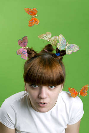 Young girl  with flying butterfliesの写真素材