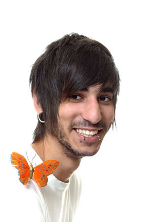 portrait of a happy smiling young good looking  man with piercing on white background.の写真素材