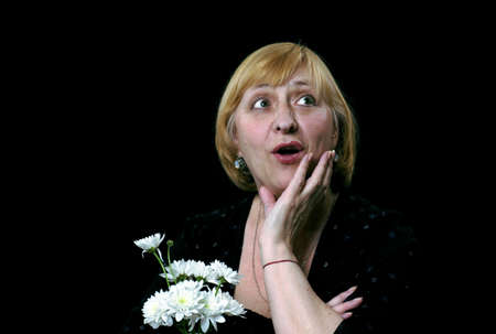 portrait of the emotional senior women with flowers の写真素材
