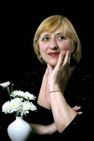 portrait of the senior women with flowers の写真素材