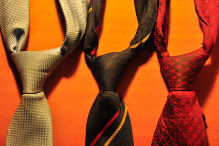 Different neckties on a hanger in a store, close-up