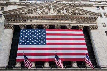 Wall street New York Stock Exchange with American flagのeditorial素材