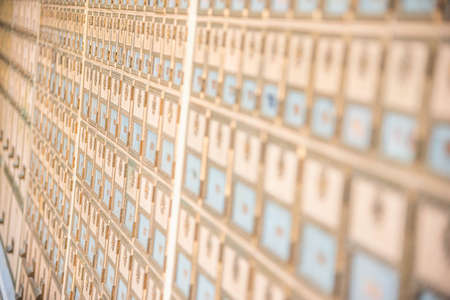 Rows of mid-century modern design post office mailboxes in brass metal.の写真素材