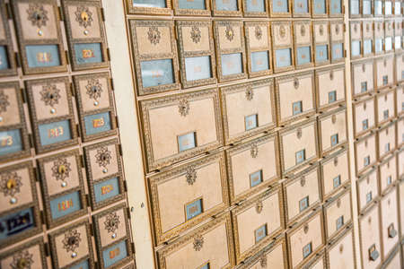 Rows of mid-century modern design post office mailboxes in brass metal.の写真素材
