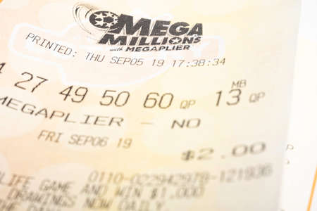 Vidalia, Georgia / USA - September 27, 2019: A macro shot of a single stack of Georgia Lotteryâs Mega Millions with Megaplier tickets on plain white background.のeditorial素材