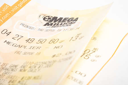 Vidalia, Georgia / USA - September 27, 2019: A macro shot of a single stack of Georgia Lotteryâs Mega Millions with Megaplier tickets on plain white background.のeditorial素材