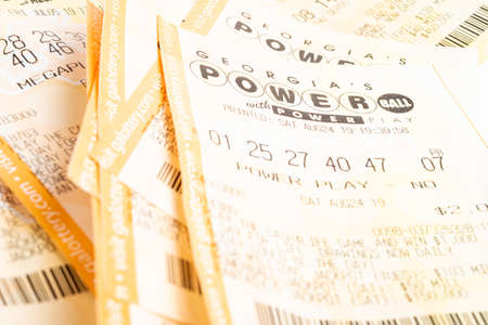 Vidalia, Georgia / USA - September 27, 2019: A macro shot of a single stack of Georgia Lotteryâs Powerball with Power Play tickets on plain white background.のeditorial素材